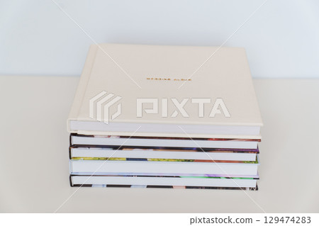 Wedding Album in gold letters on leather cover of book on books with photo cover 129474283