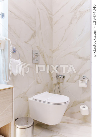 a paper strip with the inscription Sanitary safety on the toilet.  129474340