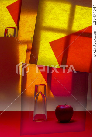 Abstract collage with an apple and a glass figure 129474544