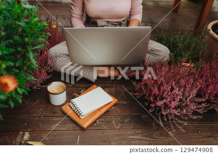 Top view of woman sitting on floor and working from homeoffice. 129474908