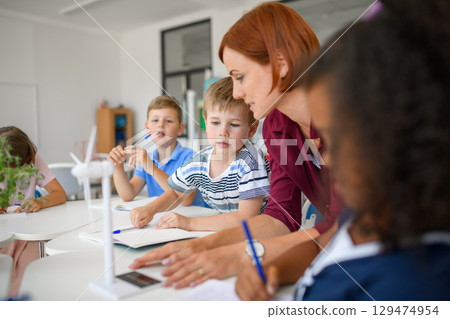 Young children learning about sustainability with teacher in classroom 129474954