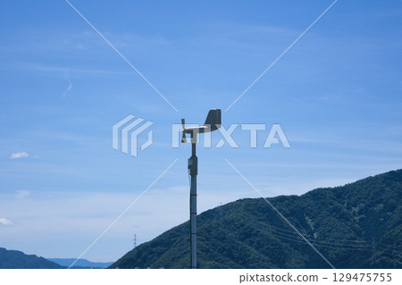 Blue sky and wind vane measuring wind speed and velocity Blue sky and wind vane measuring wind speed and velocity 129475755