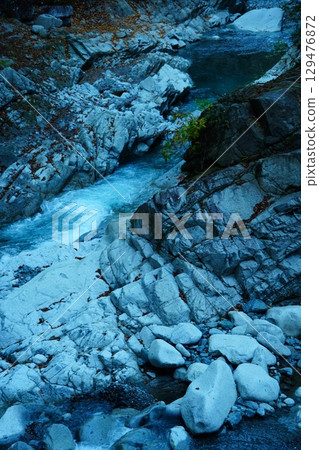 Clear stream flowing through the canyon 129476872