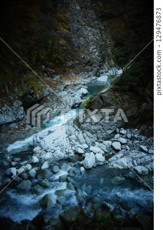 Clear stream flowing through the canyon 129476873