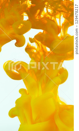 Yellow Ink Abstract Shape Under the Water. Isolated on White Background. Vertical Aspect Ratio. 129478217
