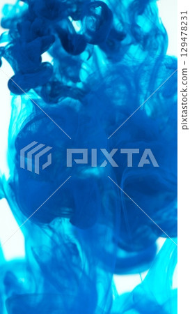 Blue Ink Abstract Shape Under the Water. Isolated on White Background. Vertical Aspect Ratio. Blue Ink Abstract Shape Under the Water. Isolated on White Background. Vertical Aspect Ratio. 129478231