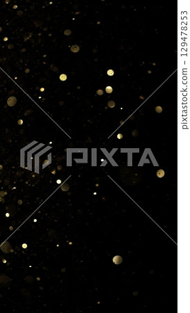 Abstract Golden Bokeh Glitter Background. Defocused Blur Spot Lights Isolated on Black Background. 129478253