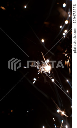 new year sparkler, fireworks. burning sparkler firework. Happy new year and Merry christmas concept. Happy holidays. Abstract blurred of Sparklers for celebration. Magic light. Winter Xmas decoration. new year sparkler, fireworks. burning sparkler firework. Happy new year and Merry christmas concept. Happy holidays. Abstract blurred of Sparklers for celebration. Magic light. Winter Xmas decoration. 129478258