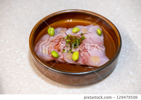 Dry aged fish with Japanese Yuzu Ponzu sauce served on plate 129478506