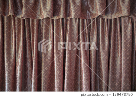 Elegant brown curtain backdrop with pleated fabric texture and patterns Elegant brown curtain backdrop with pleated fabric texture and patterns 129478790