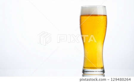 Shining tall pilsner glass of light beer with dripping condensation on a bright white background 129480264