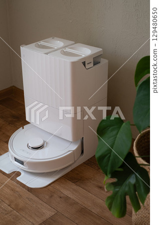 Robot vacuum works while owner rests providing clean and comfortable home with easy automatic cleaning every day 129480650
