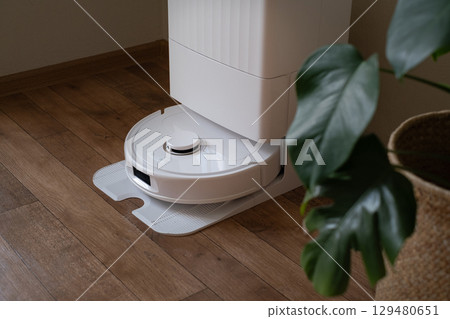 Upon finishing the cleaning job the robot vacuum heads back to its dock to prepare for the next cycle by recharging and self-emptying. Upon finishing the cleaning job the robot vacuum heads back to its dock to prepare for the next cycle by recharging and self-emptying. 129480651