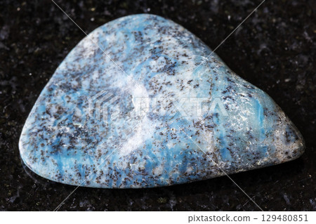 sample of rolled dianite mineral on black granite sample of rolled dianite mineral on black granite 129480851