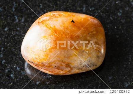 sample of tumbled orange quartz mineral on black sample of tumbled orange quartz mineral on black 129480852