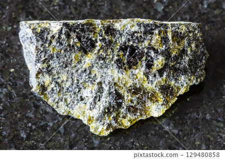 sample of rough diopside rock on black granite sample of rough diopside rock on black granite 129480858