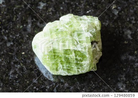 sample of raw diopside crystal on black granite sample of raw diopside crystal on black granite 129480859