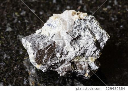sample of raw wolframite mineral on black granite sample of raw wolframite mineral on black granite 129480864