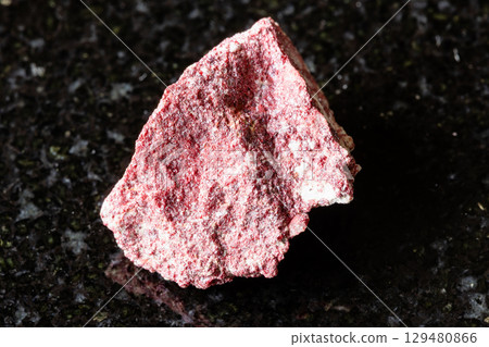 sample of raw cinnabar mineral on black granite sample of raw cinnabar mineral on black granite 129480866