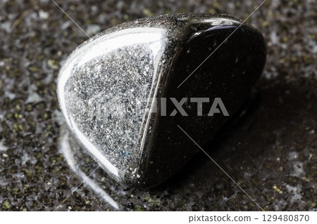 polished schorl black tourmaline mineral on black polished schorl black tourmaline mineral on black 129480870