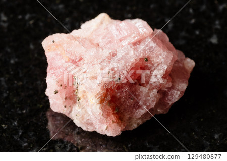 sample of raw rhodochrosite mineral on black sample of raw rhodochrosite mineral on black 129480877