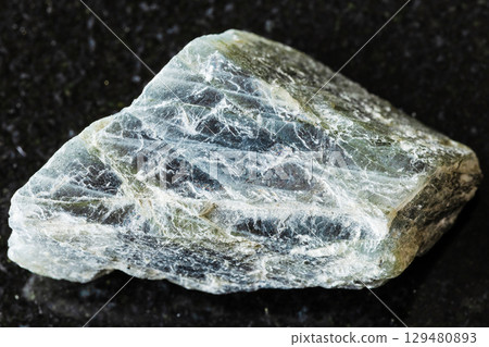 sample of raw labradorite mineral on black granite sample of raw labradorite mineral on black granite 129480893