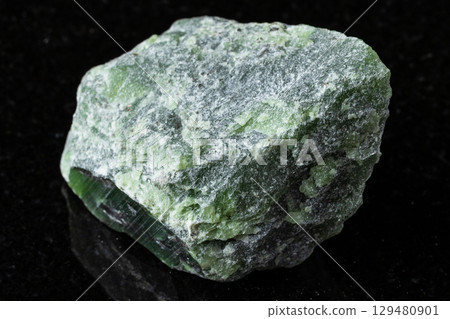 sample of raw green nephrite mineral on black 129480901