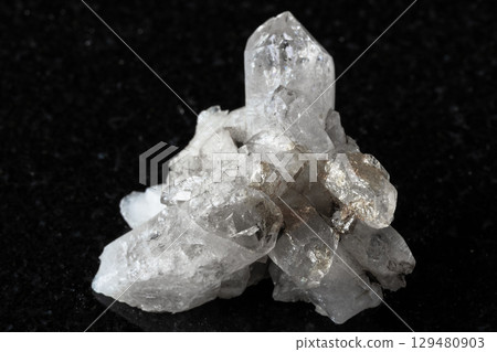 raw druse of clear quartz crystals on black 129480903