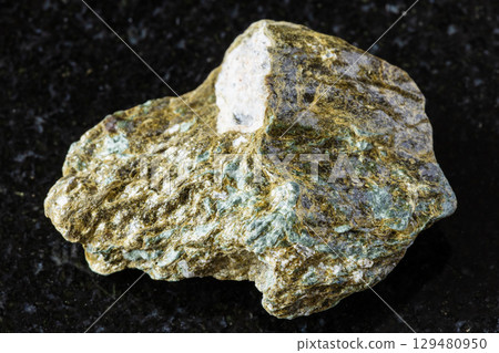 sample of raw lobanovite mineral on black granite 129480950