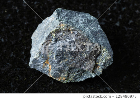 sample of raw peridotitic komatiite rock on black sample of raw peridotitic komatiite rock on black 129480973