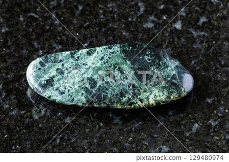 tumbled peridotitic komatiite rock on black tumbled peridotitic komatiite rock on black 129480974