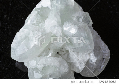 sample of raw datolite mineral on black granite sample of raw datolite mineral on black granite 129481068