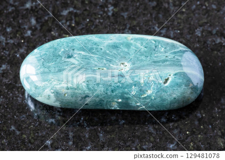 sample of tumbled chernomorite mineral on black 129481078