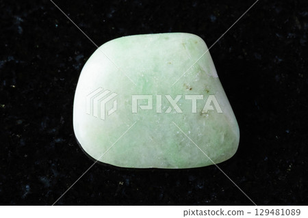 sample of polished rodingite mineral on black granite 129481089