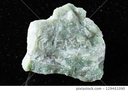 sample of raw rodingite mineral on black granite sample of raw rodingite mineral on black granite 129481090