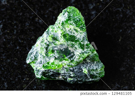 sample of raw chrome diopside mineral on black 129481105