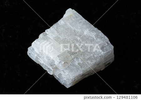 sample of raw colorless calcite mineral on black 129481106