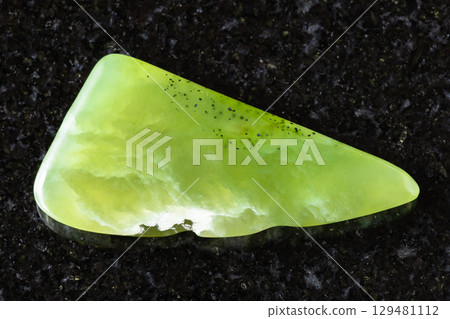 sample of polished vesuvianite mineral on black sample of polished vesuvianite mineral on black 129481112