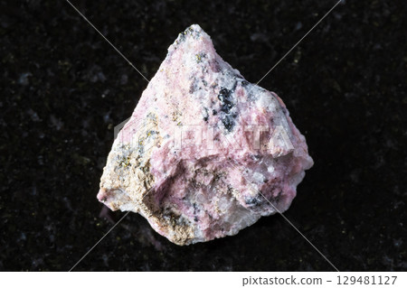 sample of raw pyroxmangite mineral on black sample of raw pyroxmangite mineral on black 129481127