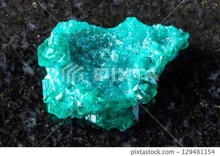 sample of raw dioptase mineral on black granite sample of raw dioptase mineral on black granite 129481154