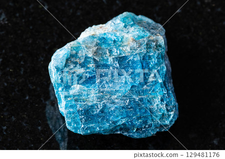 sample of rough blue apatite mineral on black sample of rough blue apatite mineral on black 129481176