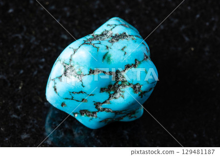 sample of tumbled turquenite mineral on black 129481187
