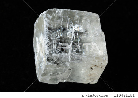 sample of raw iceland spar mineral on black 129481191