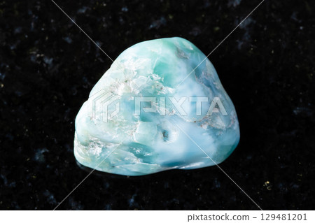 sample of raw larimar mineral on black granite 129481201