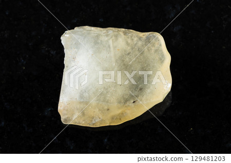 sample of raw libyan desert glass on black granite sample of raw libyan desert glass on black granite 129481203