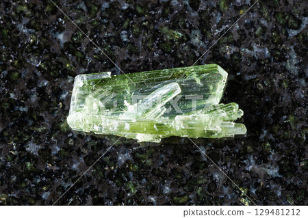 sample of unpolished zoisite crystals on black 129481212
