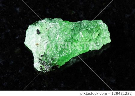 sample of raw tsavorite garnet mineral on black sample of raw tsavorite garnet mineral on black 129481222