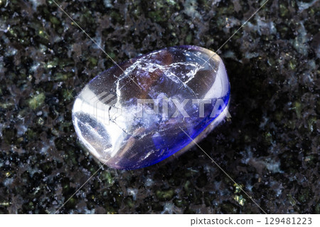 sample of polished iolite mineral on black granite sample of polished iolite mineral on black granite 129481223