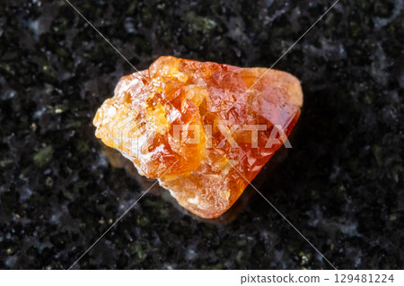 sample of unpolished scheelite mineral on black sample of unpolished scheelite mineral on black 129481224