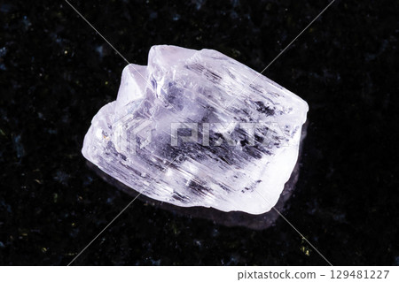 sample of raw kunzite mineral on black granite sample of raw kunzite mineral on black granite 129481227